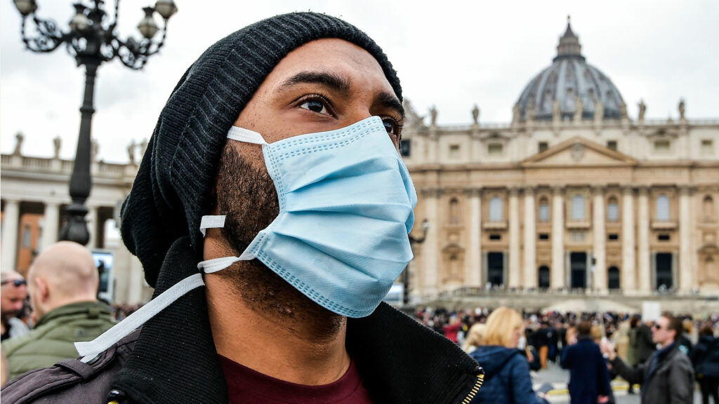 Angst vor dem Coronavirus. Ein Mann trägt eine Atemschutzmaske während des Angelusgebets mit Papst Franziskus am 2. Februar auf dem Petersplatz. | © KNA-Bild